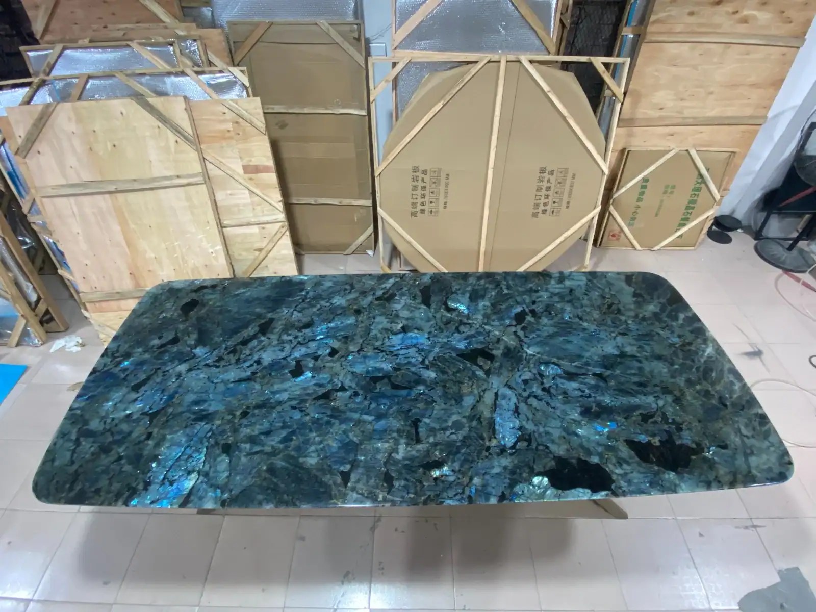 Custom labradorite stone dining table with iridescent blue veining