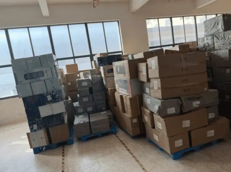 Cartons from multiple suppliers labeled and stacked on pallets in a China warehouse