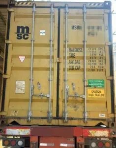 Rear doors of a closed shipping container on a trailer at a China export warehouse