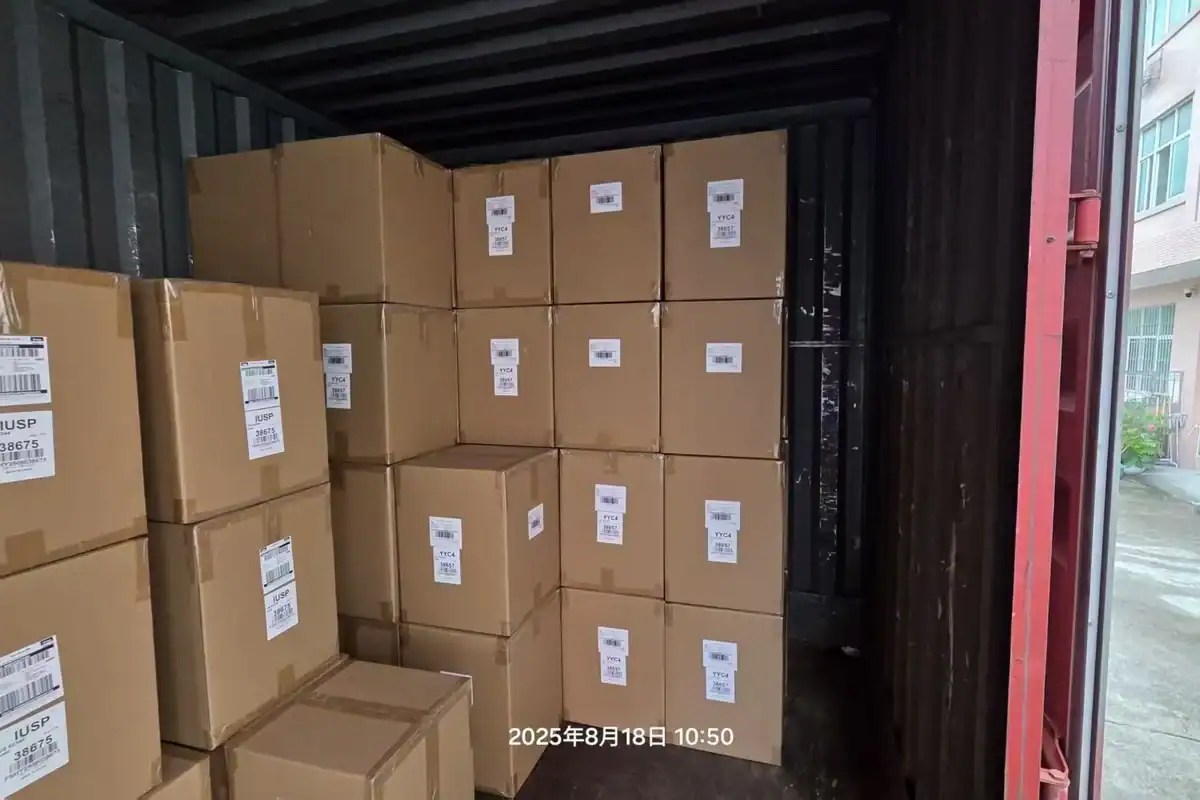 Cartons from the first production run of a new product being loaded into a container at a factory in China