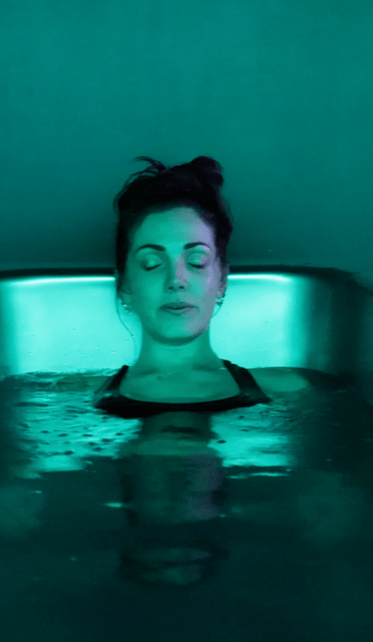 Woman in cold plunge tub at MindFuel Method, Pittsburgh's sauna and ice bath studio