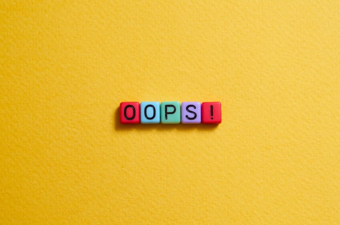 ‘oops!’ written on colourful beads