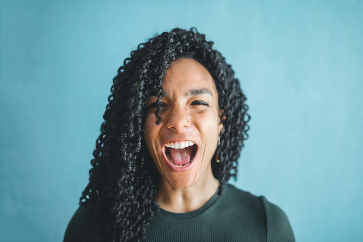 Woman in knitted top is screaming with excitement