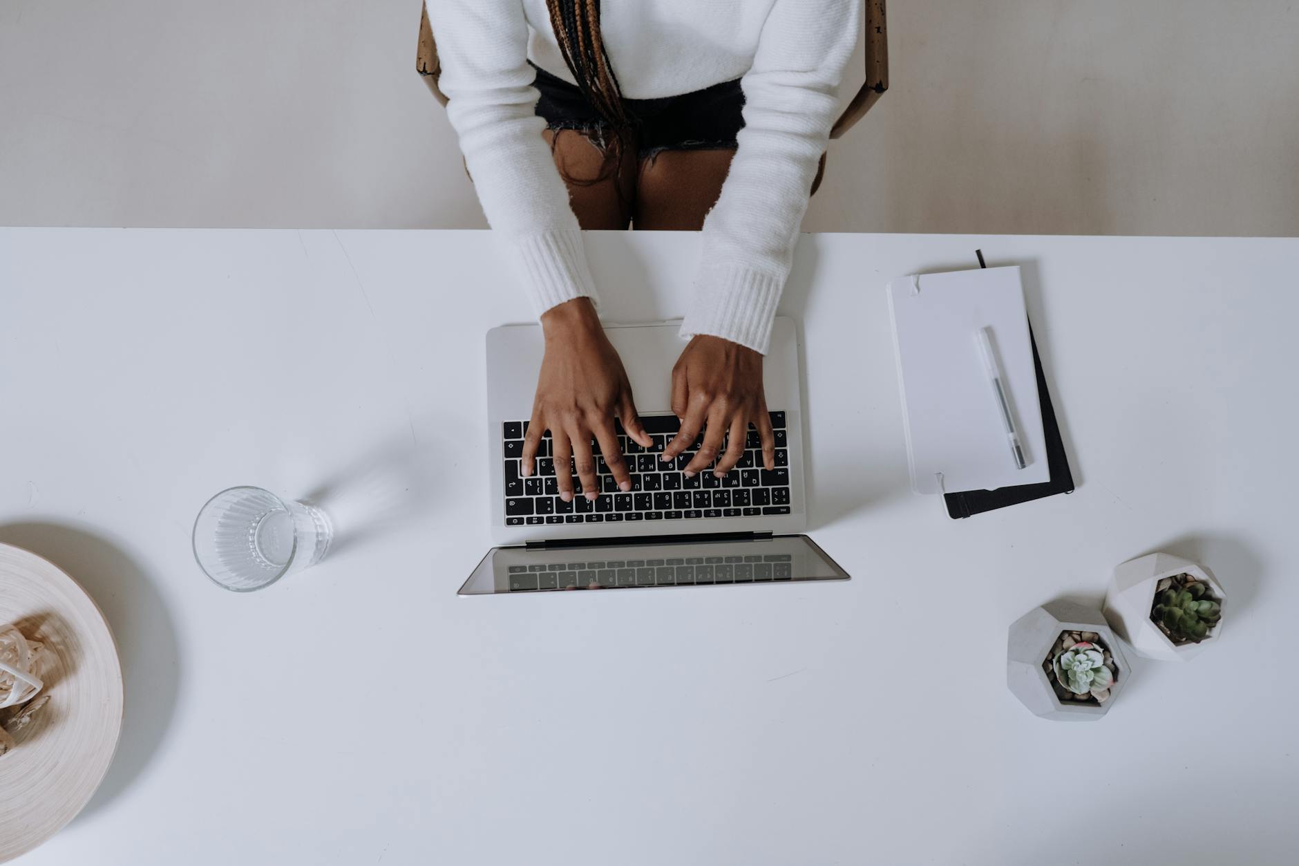 A person working on a laptop in a relaxed home environment.