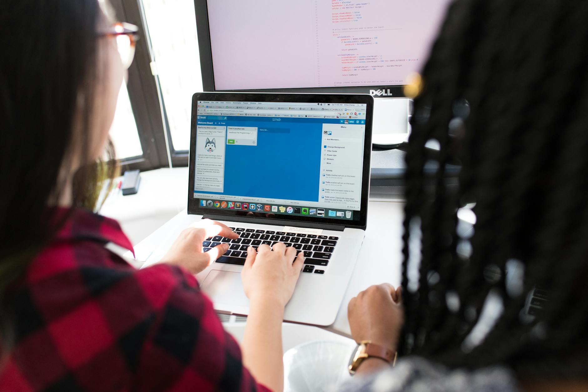 A person working on a laptop with code on the screen, representing a blockchain developer.