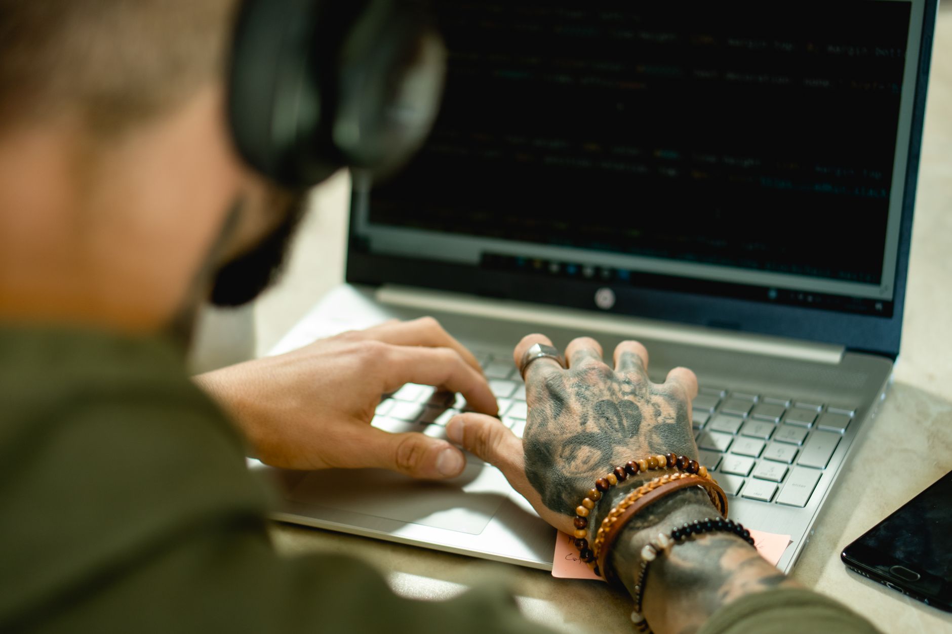 A person typing on a laptop, illustrating the process to hire developers.