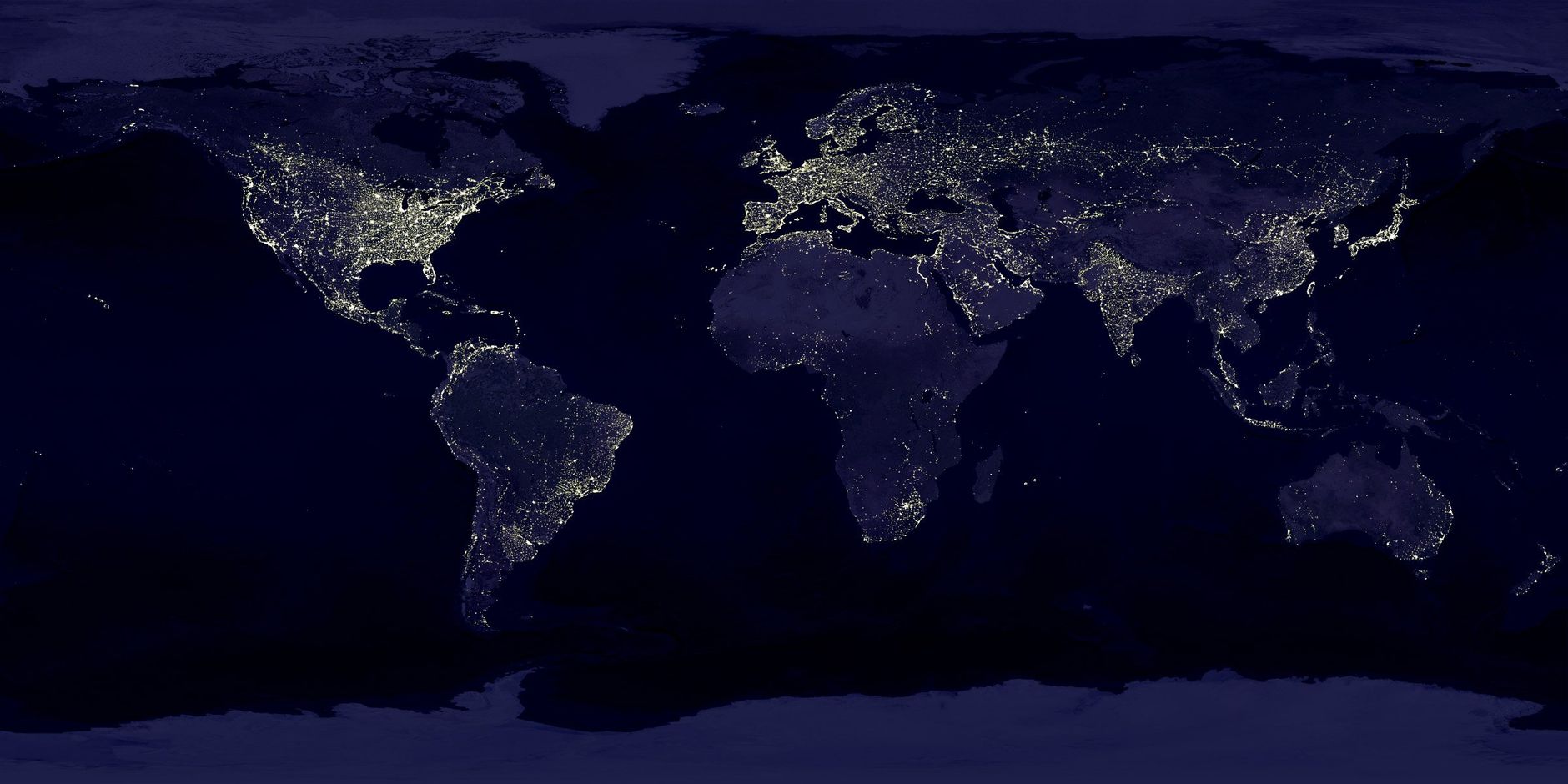 A view of the Earth at night from space, showing city lights across continents.