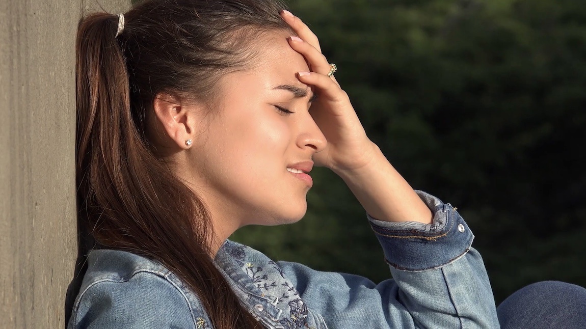 Girl crying from bullying and feeling broken and beaten.
