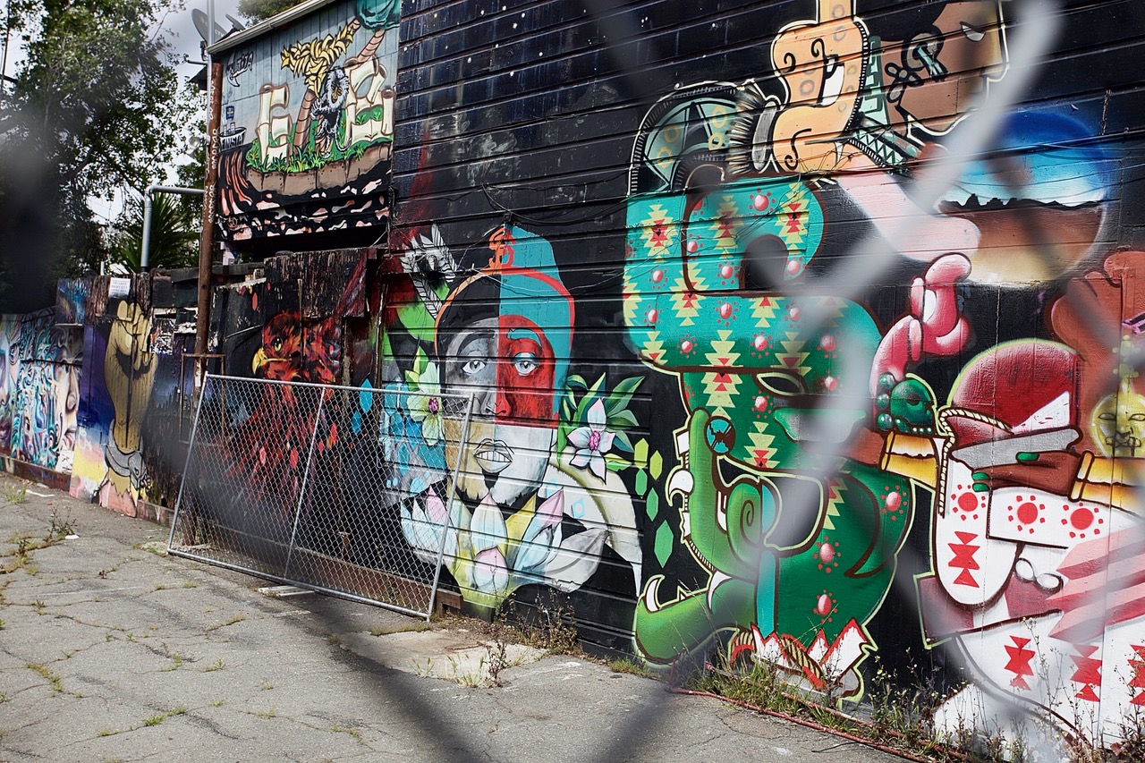 Mural through fence on 24th Street