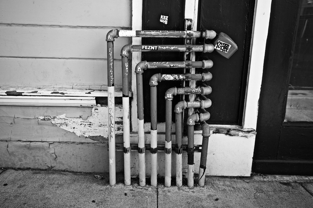 A series of pipes against a building on 25th Street.