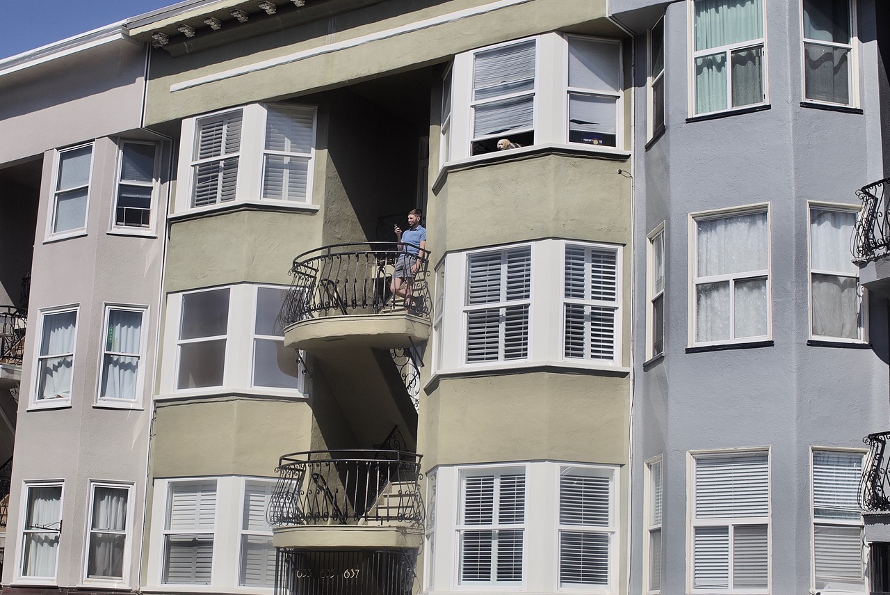 A man checking his phone on the stairwell.