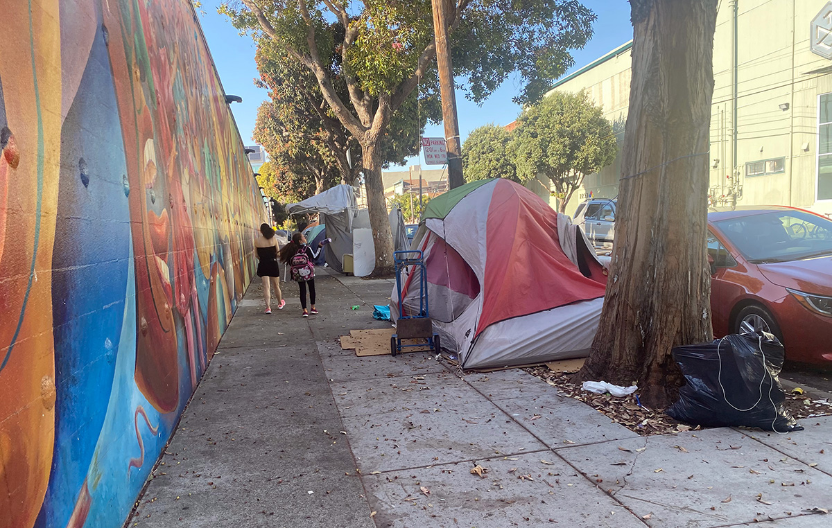 A row of two or three tents along Harrison Street.