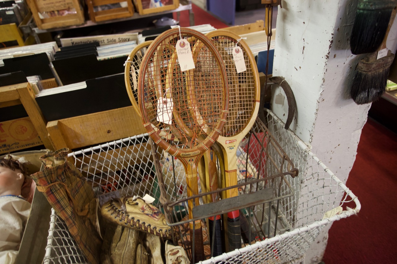 tennis rackets in a wire basket