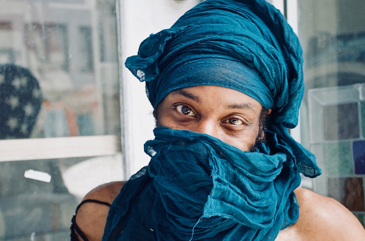 headshot of a person in an indigo scarf