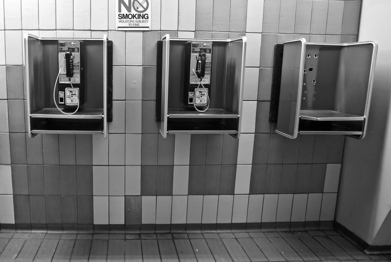 Three pay phones in a line.