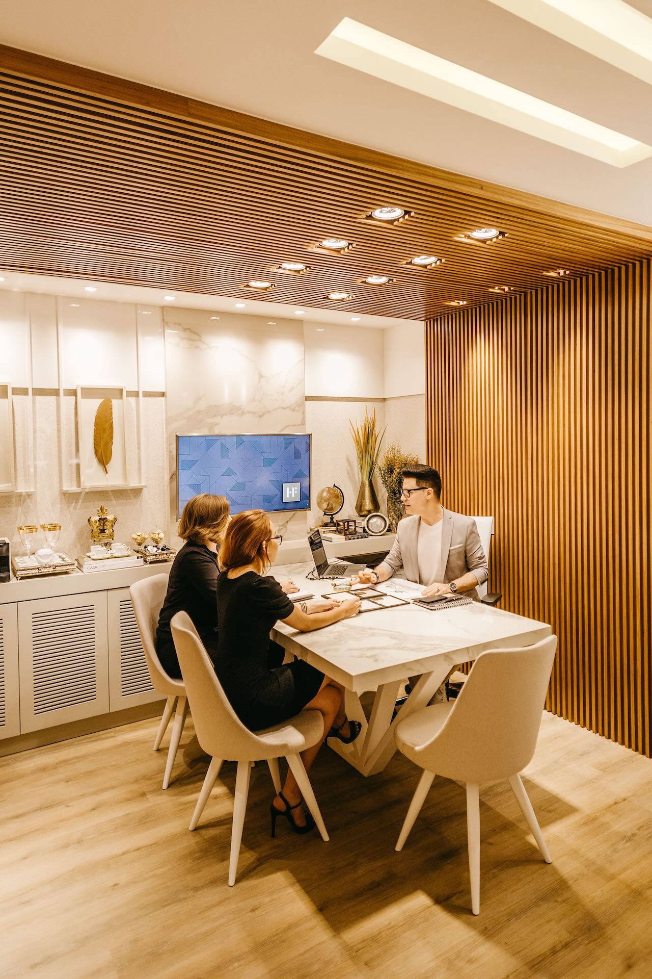 Three people having a meeting in a corporate office | Featured Image for the Employee Performance Management Consultant Page of MJSP.