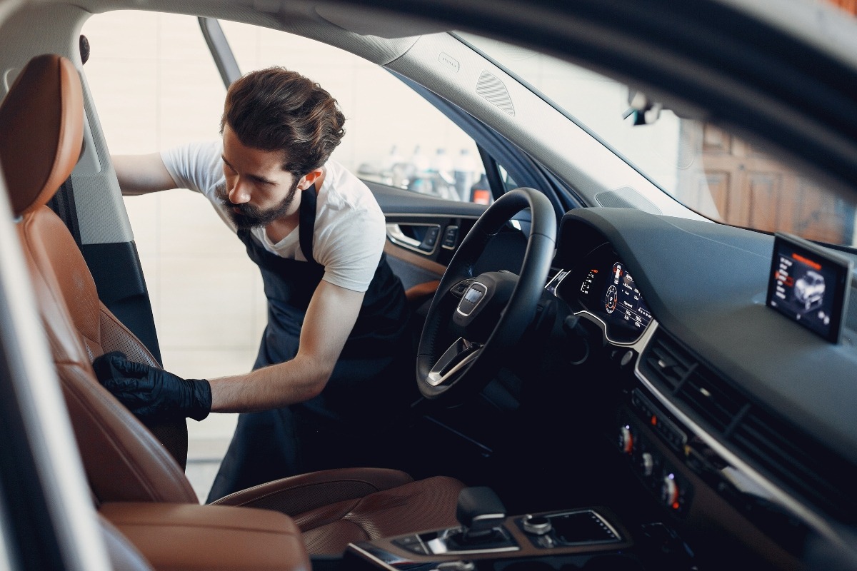 Man cleaning car interior
