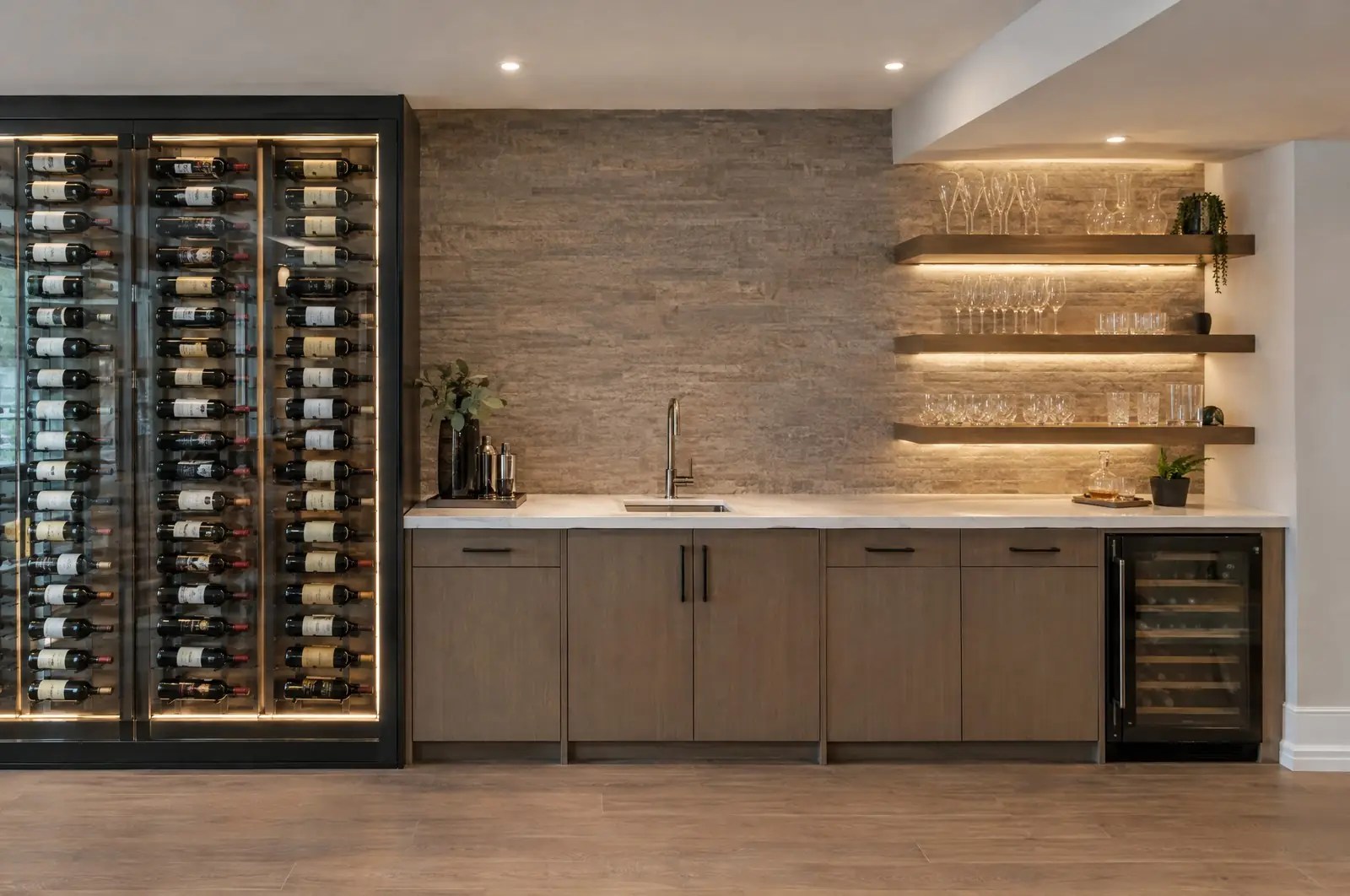 A basement wet bar: wine wall, stone bar top and backlit shelving