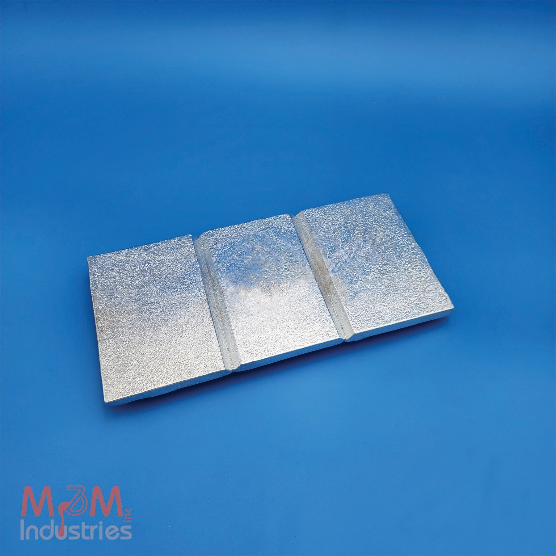 M&M Industries manufactures the M10 3 Sectional Zinc Plate Anode in the USA. M&M hand casts the M10 as a solid block of MIL-A-18001 zinc alloy. The M10 3 sectional zinc plate anode weighs a nominal 10 lbs and provides dependable sacrificial corrosion protection across a wide range of marine, industrial, and submerged metal applications. The plate measures ½" x 6" x 12". M&M supplies the M10 zinc plate is undrilled and unmachined, so customers cut, drill, machine, or fabricate it to meet specific installation requirements. The M10 is ideal for custom cathodic protection applications. It serves vessels, docks, pilings, seawater systems, ballast tanks, heat exchangers, industrial equipment, and other structures exposed to corrosive environments. Its solid zinc construction gives engineers, fabricators, and maintenance teams a flexible and reliable corrosion protection solution.