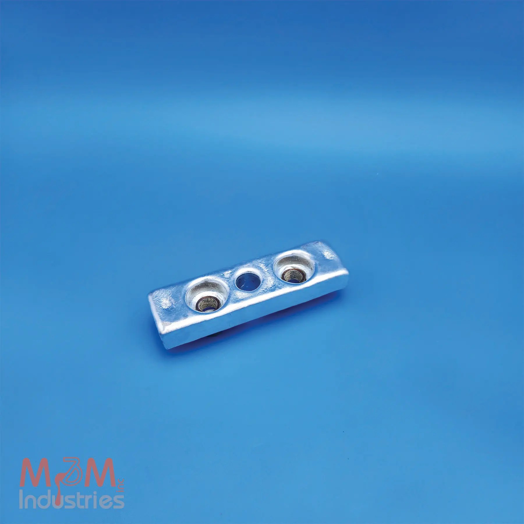 The ZKC-4 Keel Cooler Zinc Sacrificial Anode measures 7" x 2" x 1" and weighs 2.7 lbs. M&M Industries manufactures each ZKC-4 in the USA from high purity MIL-A-18001 zinc alloy providing dependable cathodic protection. Our team gravity casts every ZKC-4 anode in a controlled U.S. foundry. This proven method ensures consistent alloy chemistry, dimensional accuracy, and effective corrosion protection. M&M equips each ZKC-4 anode with two galvanized steel pipe cores featuring a 0.62" inside diameter (ID), allowing for secure mounting on keel coolers and other marine equipment. The pipe cores position the mounting holes 3-¼" center-to-center and provide a 7/8" diameter center hole to simplify installation with straightforward mounting configurations. The ZKC-4 helps protect keel coolers, heat exchangers, and other submerged metal components from galvanic corrosion, extending equipment service life and reducing maintenance requirements.