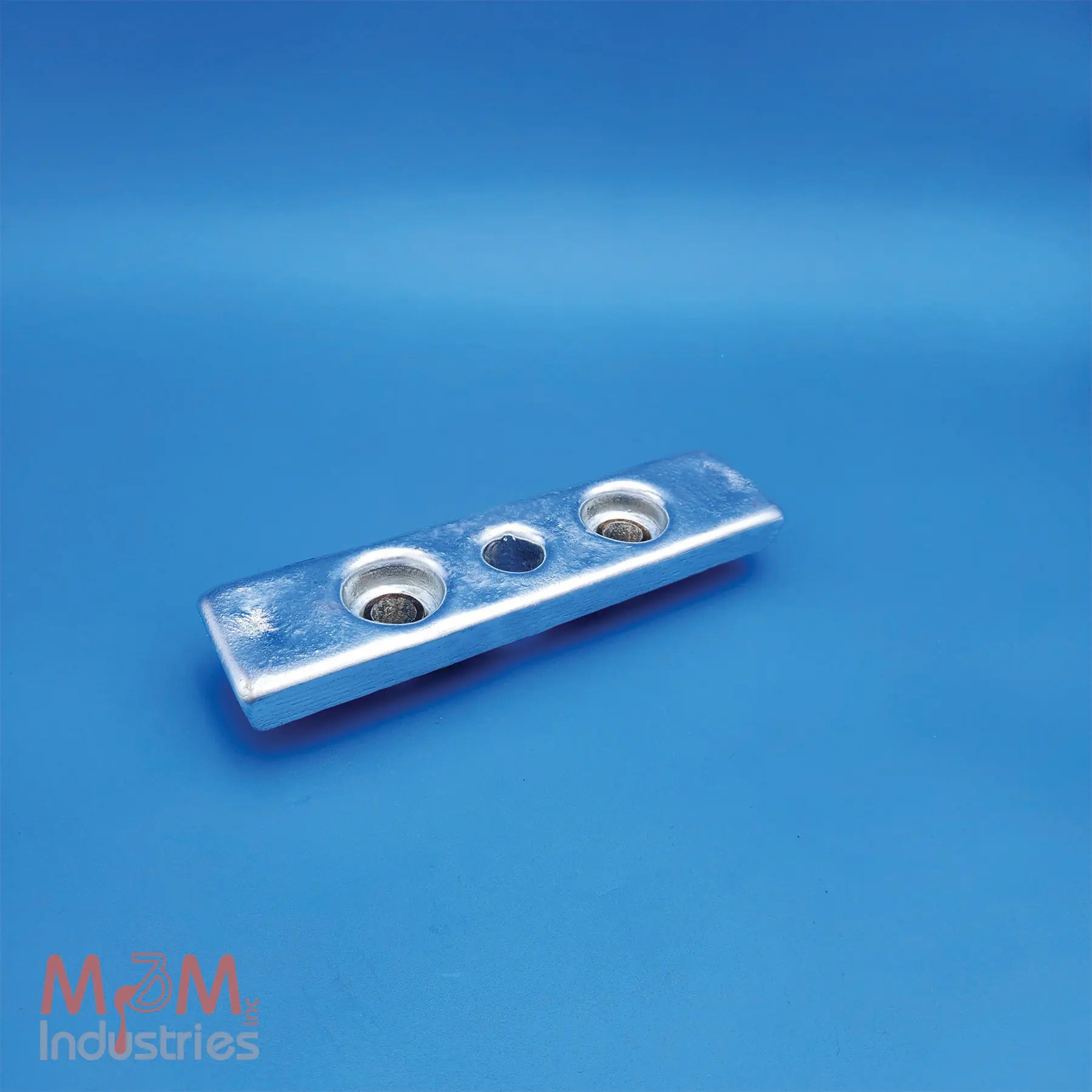 The ZKC-5 Keel Cooler Zinc Sacrificial Anode measures 9" x 2" x 1" and weighs 2.7 lbs. M&M Industries manufactures each ZKC-5 in the USA from high purity MIL-A-18001 zinc alloy providing dependable cathodic protection. Our team gravity casts every ZKC-5 anode in a controlled U.S. foundry. This proven method ensures consistent alloy chemistry, dimensional accuracy, and effective corrosion protection. M&M equips each ZKC-5 anode with two galvanized steel pipe cores featuring a 0.62" inside diameter (ID), allowing for secure mounting on keel coolers and other marine equipment. The pipe cores position the mounting holes 4" center-to-center and provide a 7/8" diameter center hole to simplify installation with straightforward mounting configurations. The ZKC-5 helps protect keel coolers, heat exchangers, and other submerged metal components from galvanic corrosion, extending equipment service life and reducing maintenance requirements.