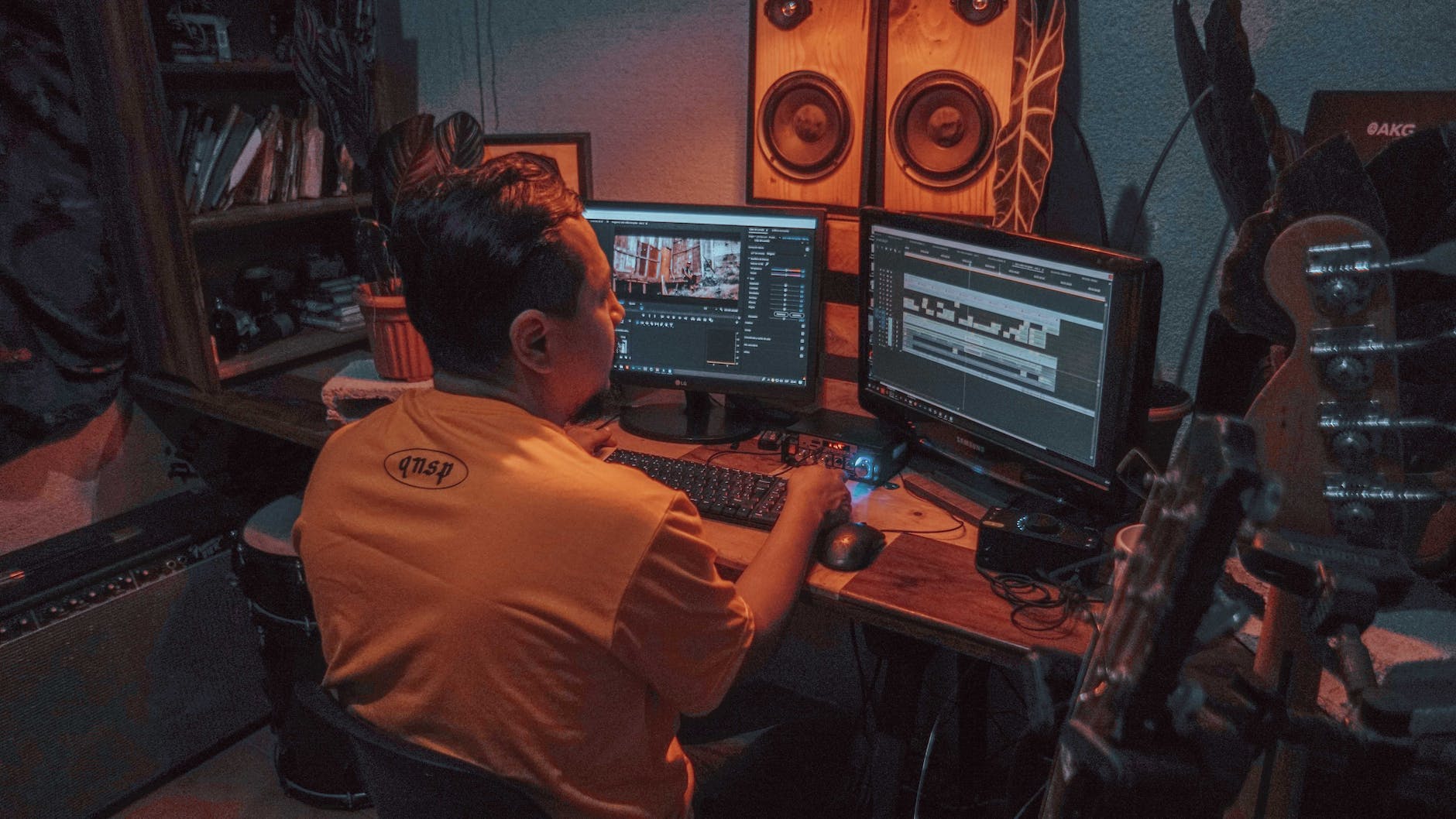 man sitting in front of two monitors