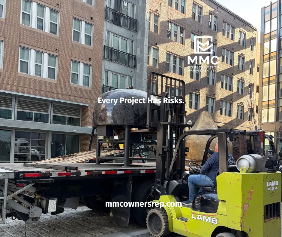 Forklift removing a commercial pizza oven from Salt + Stone restaurant during the renovation project.