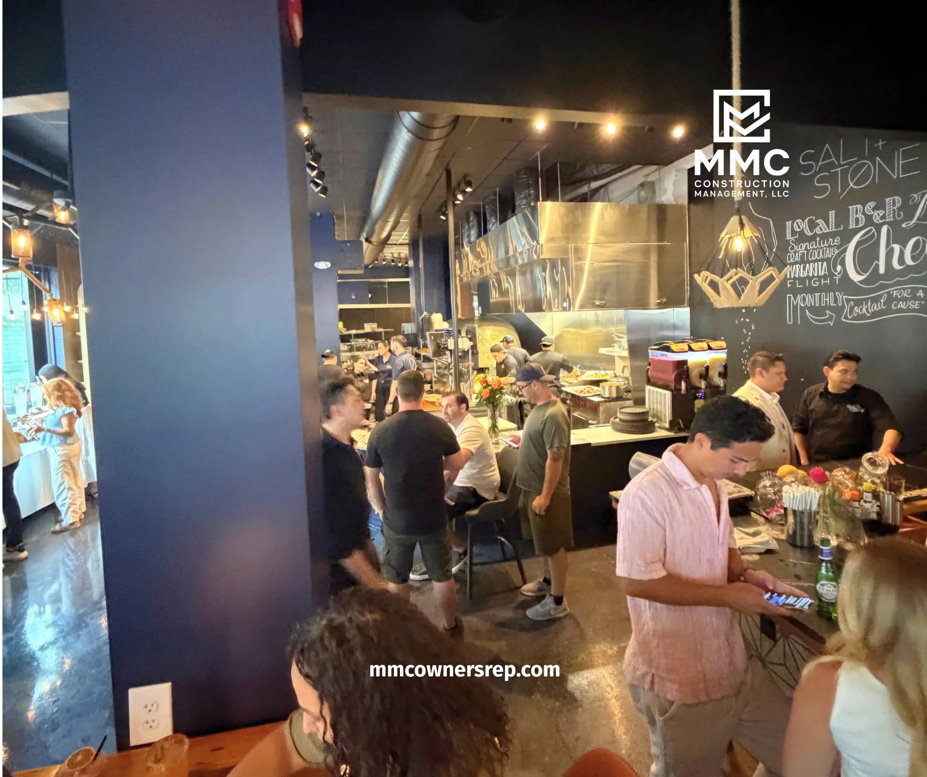 Attendees celebrating the reopening of Salt + Stone restaurant after the completed commercial renovation coordinated by MMC Construction Management.