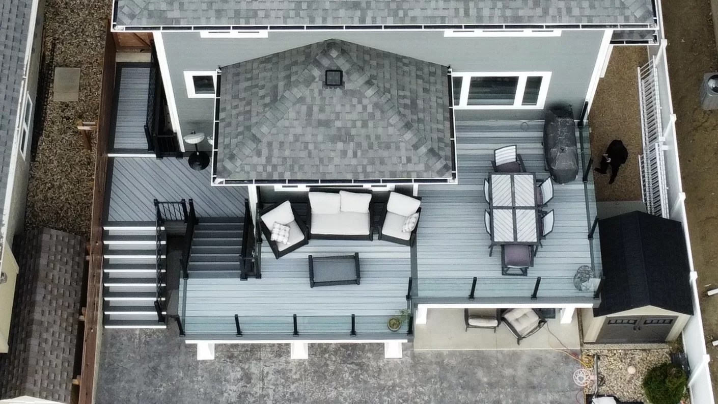 Trex composite deck with frameless glass railing built in Stonebridge, SK