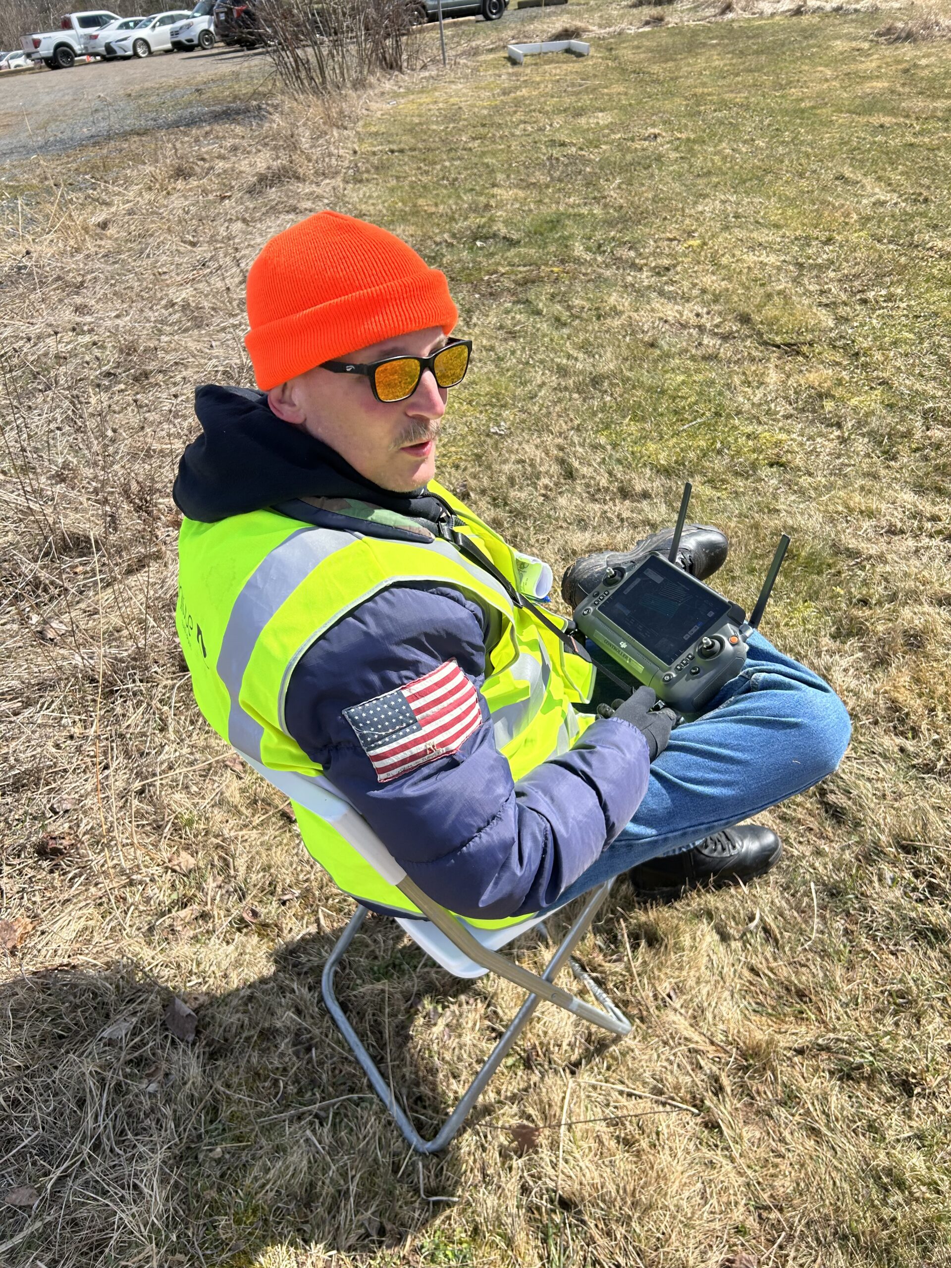 Drone operator flying a UAV in the field