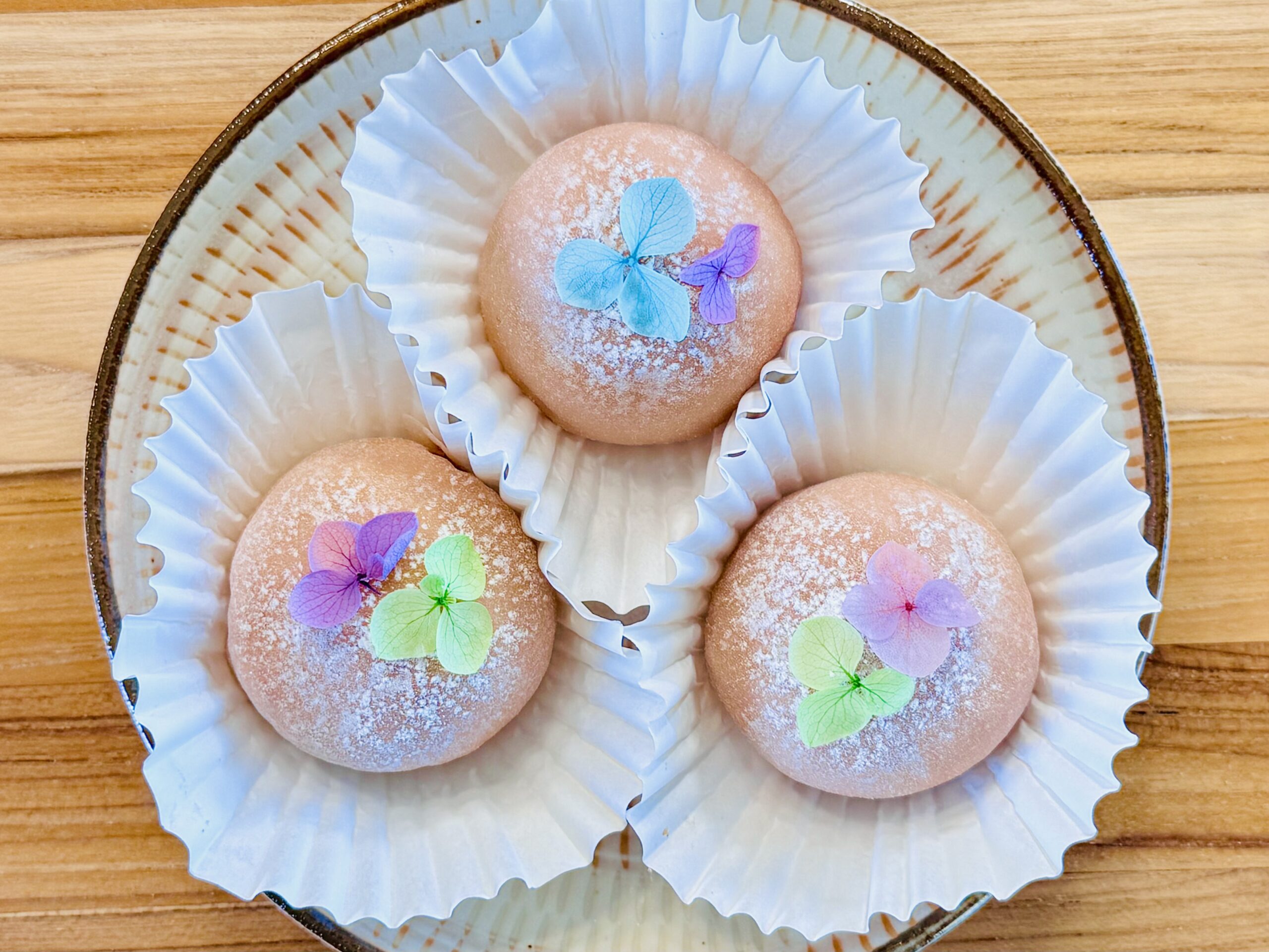 Low carb strawberry daifuku mochi dusted with glutinous rice flour on a plate