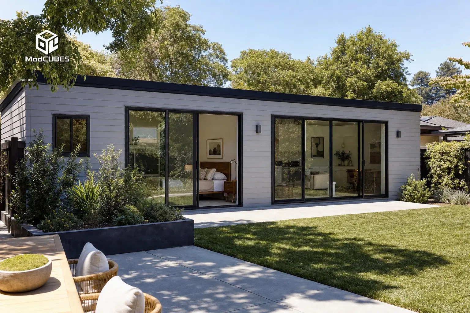 Peakline modular ADU with dark exterior, large windows and outdoor patio