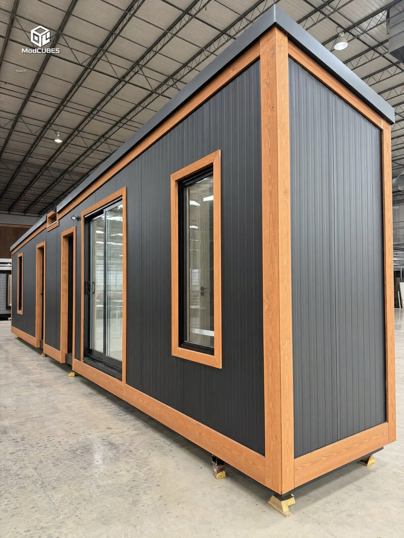 Black steel-frame modular unit being assembled at the factory