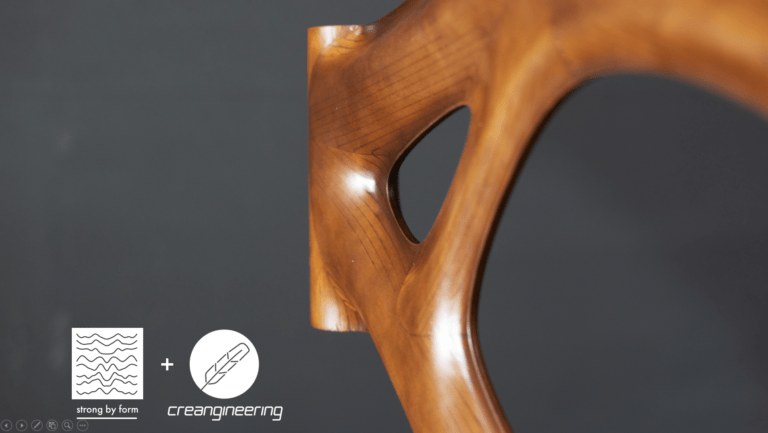 Close-up of wooden frame with organic design by Strong by Form and Creangineering, showcasing sustainable composite material innovation.