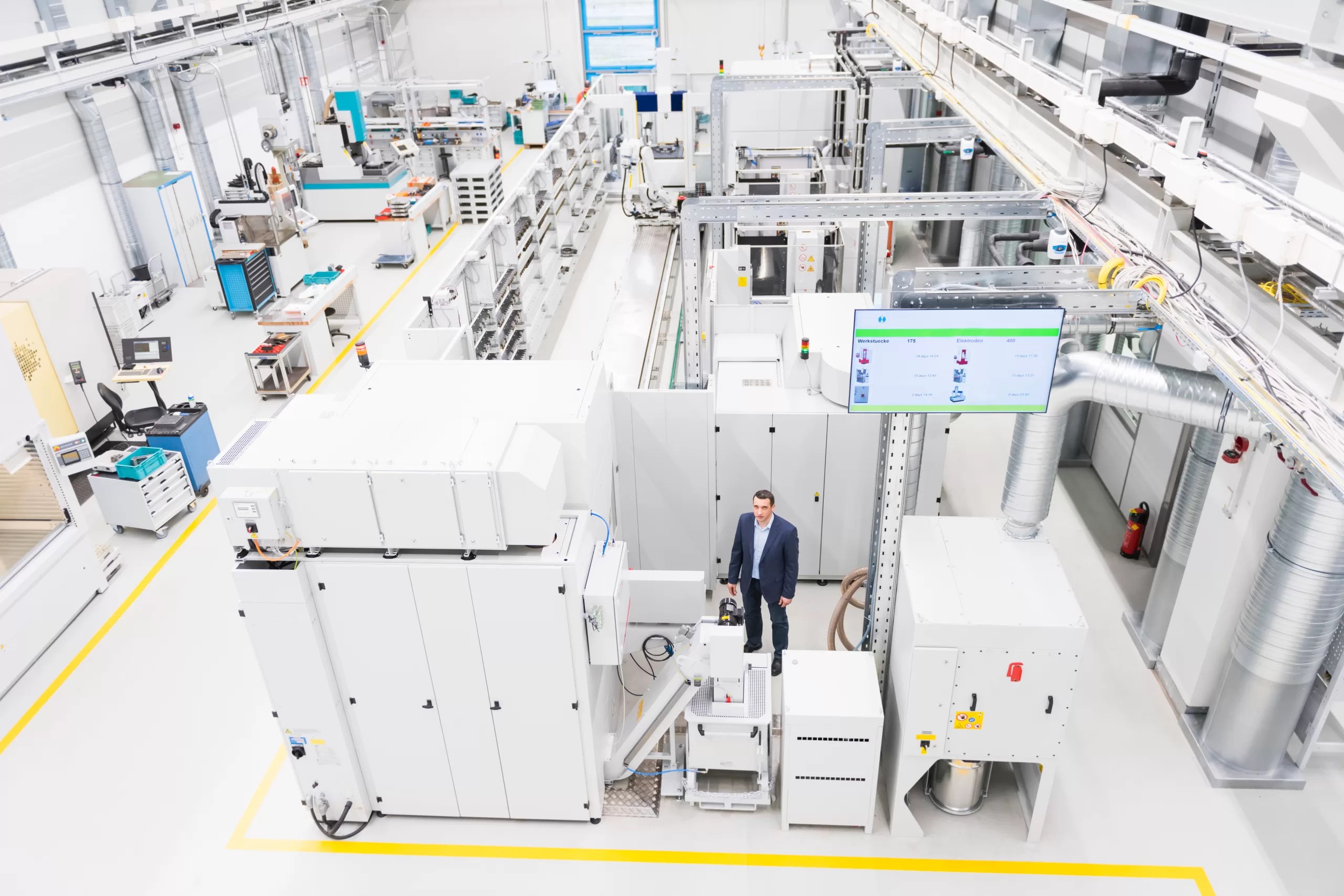 Engineer in smart factory operating advanced industrial automation equipment for precision manufacturing and digital production