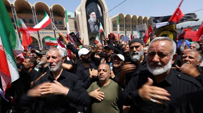 Massive crowds of black-clad mourners gather at Tehran’s Grand Mosalla mosque as Iran begins a highly volatile, six-day funeral for its assassinated Supreme Leader.