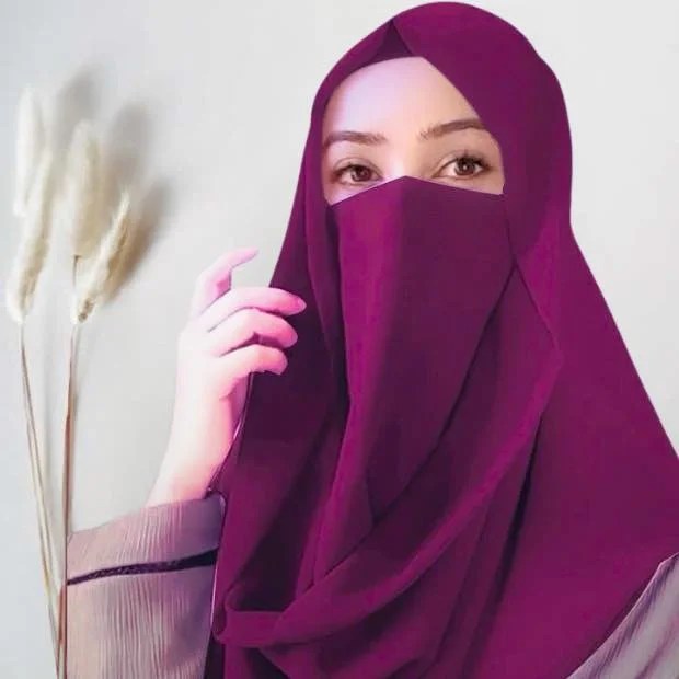 Woman with a Misri-style wrap, scarf ends over her shoulder. Modify.pk