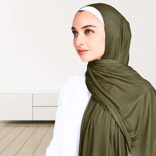A woman wearing a draped ribbed jersey hijab. Modify.pk