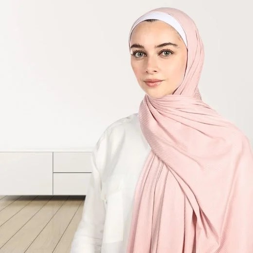 A woman wearing a draped ribbed jersey hijab. Modify.pk
