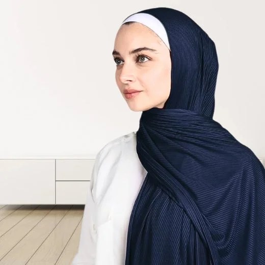 A woman wearing a draped ribbed jersey hijab. Modify.pk