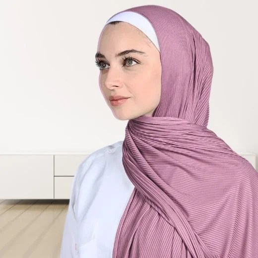 A woman wearing a draped ribbed jersey hijab. Modify.pk