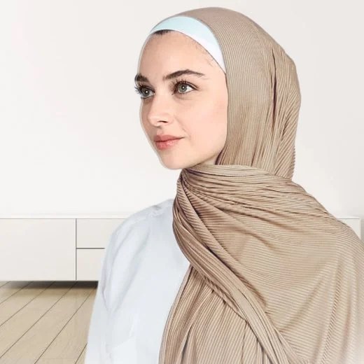 A woman wearing a draped ribbed jersey hijab. Modify.pk
