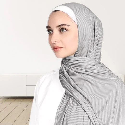 A woman wearing a draped ribbed jersey hijab. Modify.pk