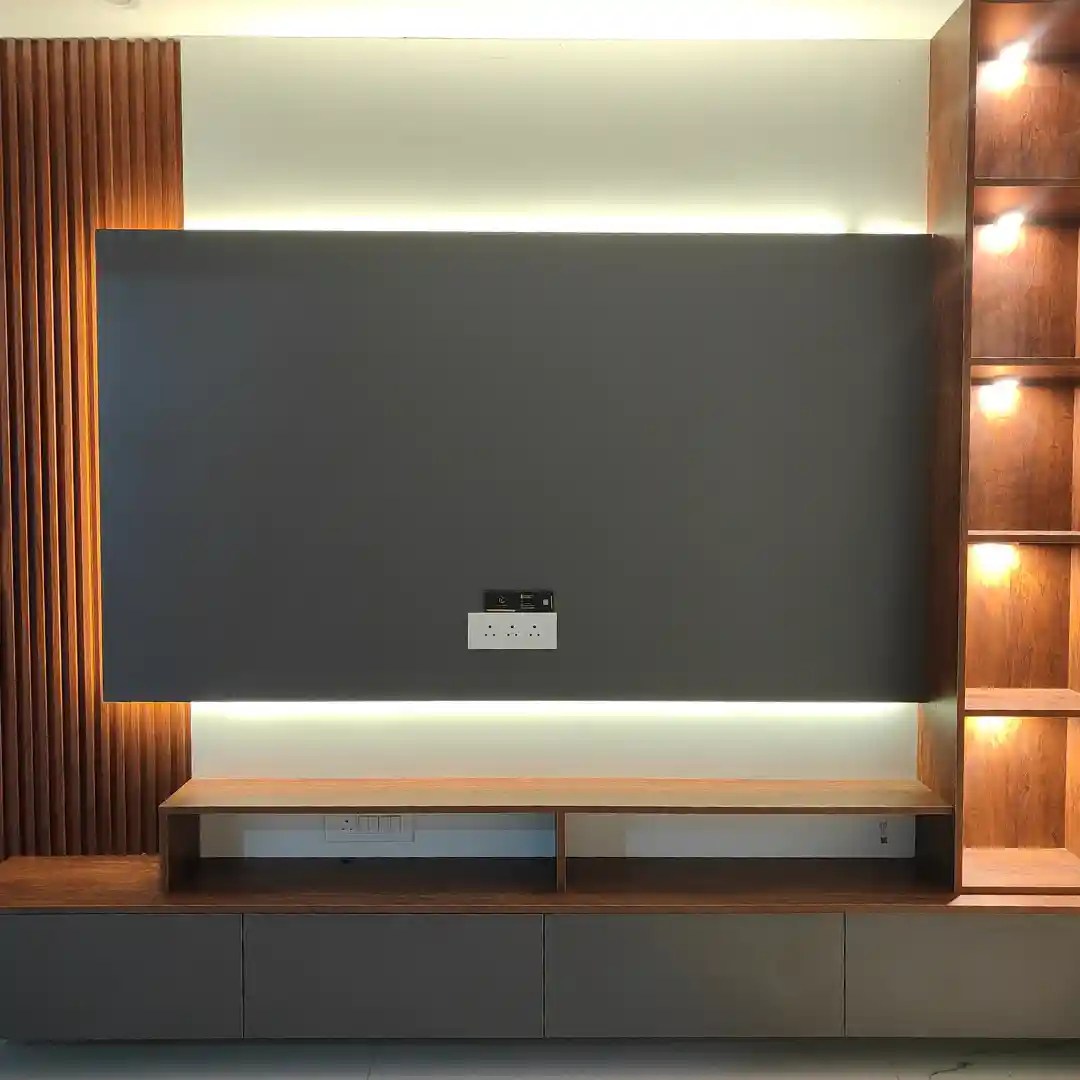 Modern TV wall with wooden slat panel, LED lighting, open shelves, and black accent — sleek living room design