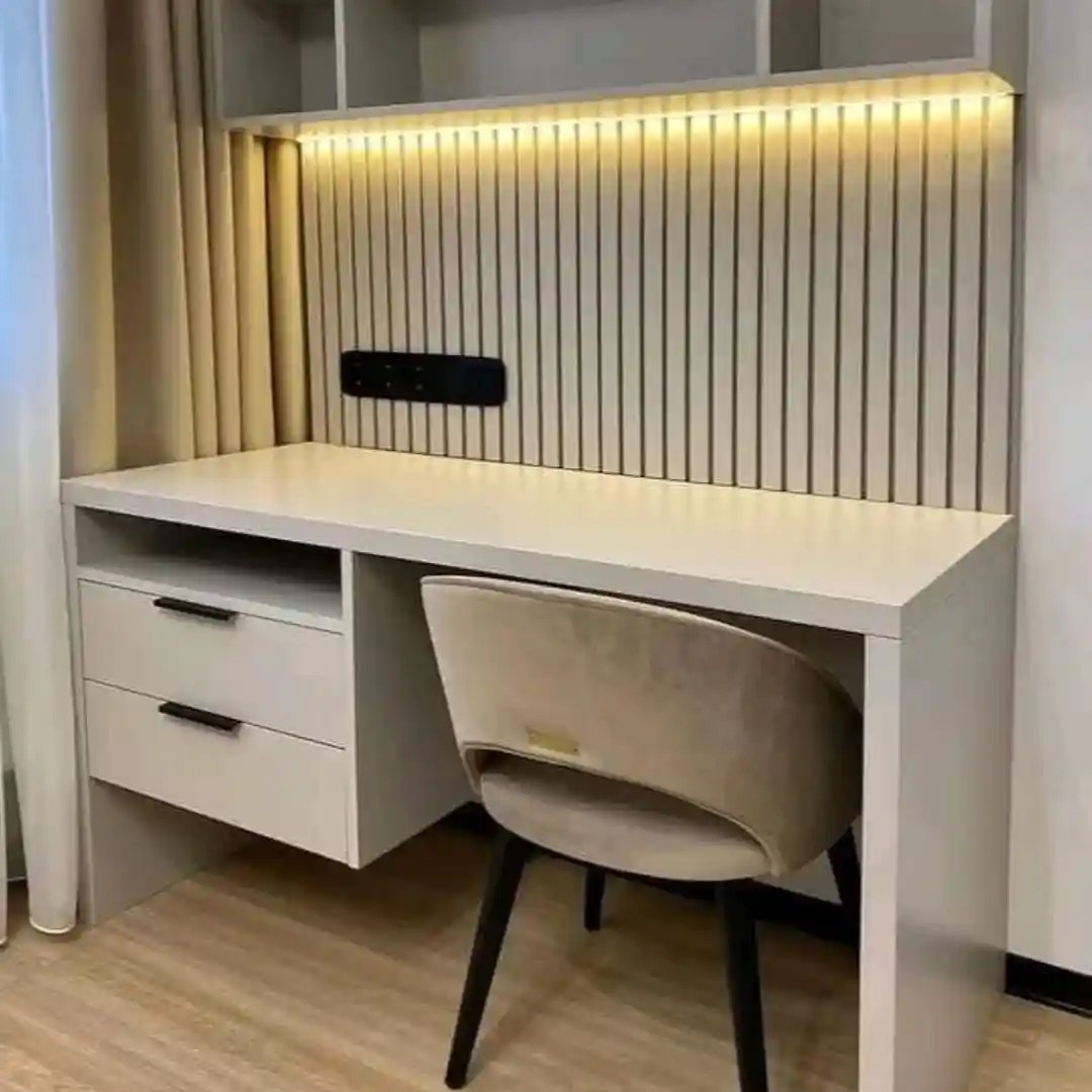 Modern study desk with white top, LED lighting, drawers, slatted panel, and beige chair — sleek home office design