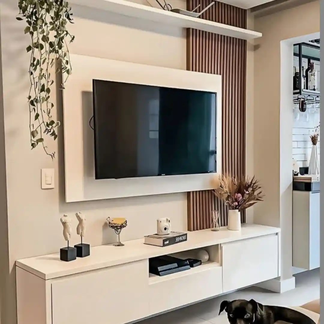 Modern TV wall with white frame, wooden slats, floating shelf, and white cabinet — minimalist living room design
