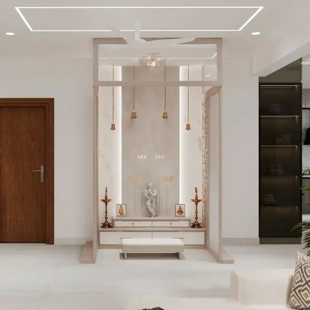 Minimalist modern pooja room with Krishna idol, hanging bells, LED lighting, and marble finish — elegant Indian prayer space design