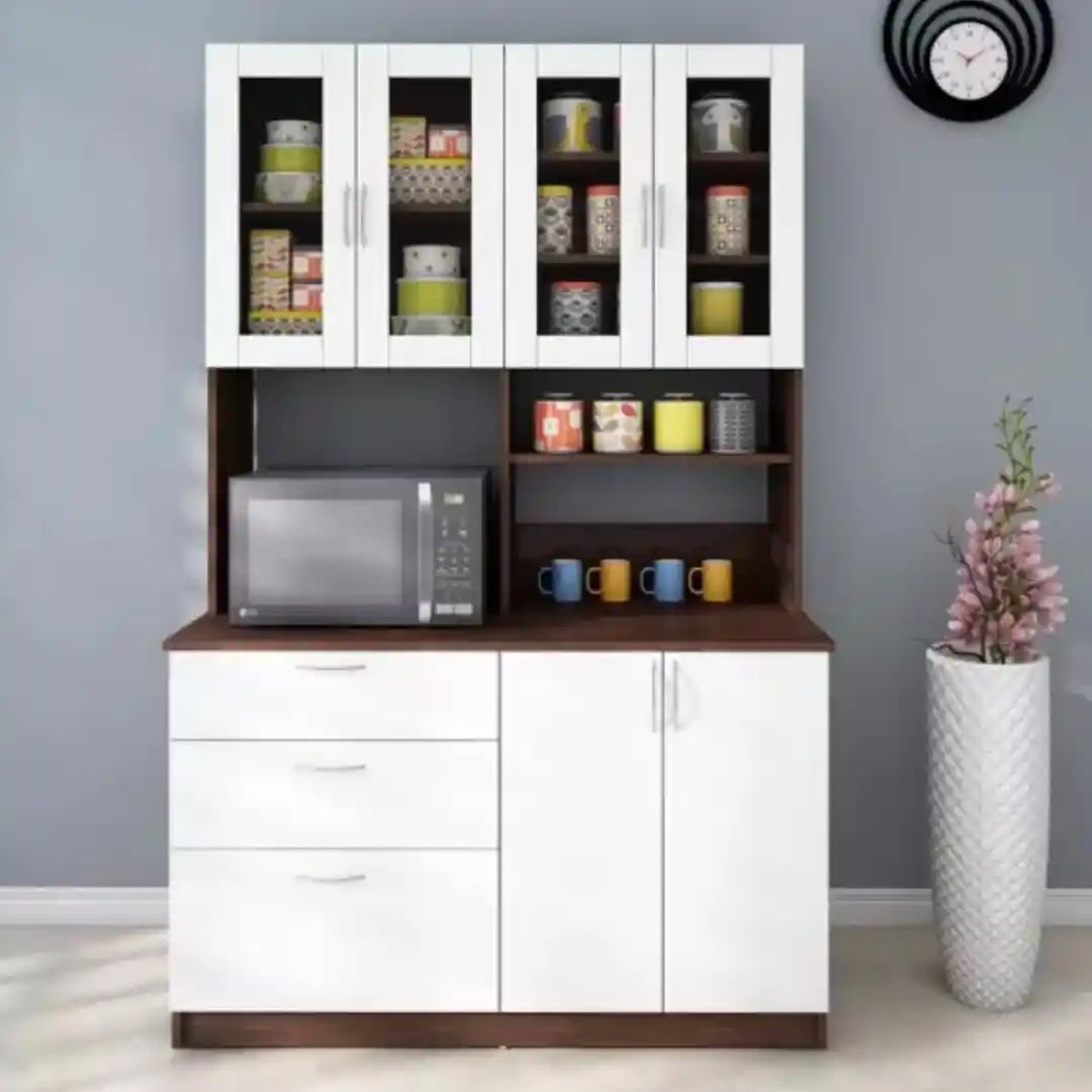 Modern kitchen cabinet with microwave, glass doors, and colorful mugs.
