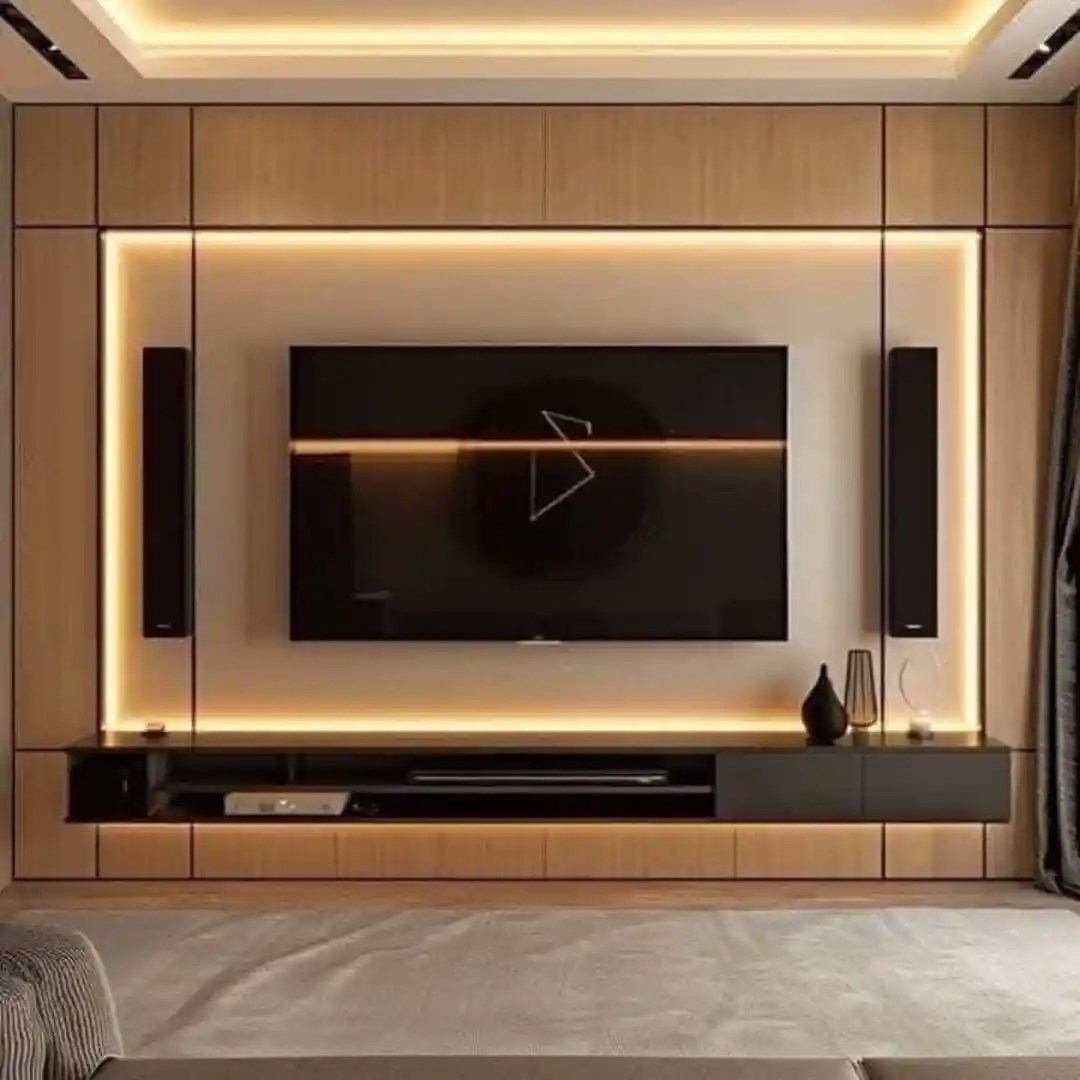 Modern TV wall with wooden panel, LED lighting, floating cabinet, speakers, and minimalist design — elegant living room setup