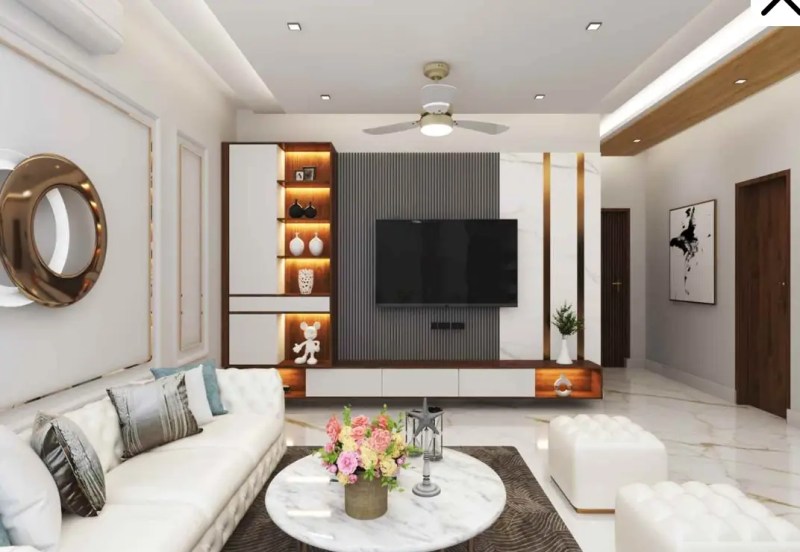 Modern living room with a stylish TV unit, white sofa, marble flooring, and ambient lighting, perfect for homes in Delhi NCR.